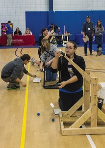Photo by Julia Johnson Super Hyper Friends Squad from East Alton Wood River High School (bottom to top) Samantha Johnson, Becca Renken and Bradley Swarringin compete with their trebuchets.
