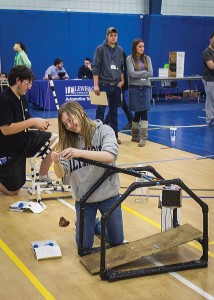 Photo by Julia Johnson Super Hyper Friends Squad from East Alton Wood River High School members (bottom to top) Becca Renken and Bradley Swarringin ready their trebuchets while Judges Matt St. Cin and Victoria Borgini observe.