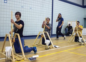 Photo by Julia Johnson The Wacky Waving Inflatable Arm Flailing Tube Man Team from Jersey Community High School members (L to R) Trevor Ayres, Jake Breitweiser, Ryan Peterson (walking) and Brendan Vanost compete with their trebuchets.