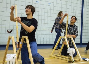 The Wacky Waving Inflatable Arm Flailing Tube Man Team from Jersey Community High School members (L to R) Trevor Ayres, Jordan Sievers (walking) and Jake Breitweiser compete with their trebuchets.