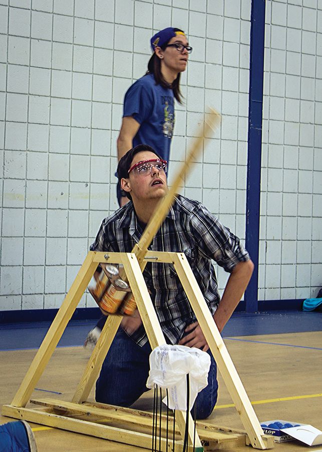 Photo by Julia Johnson The Wacky Waving Inflatable Arm Flailing Tube Man Team from Jersey Community High School members (bottom to top): Jake Breitweiser and Ryan Peterson compete with their trebuchet.