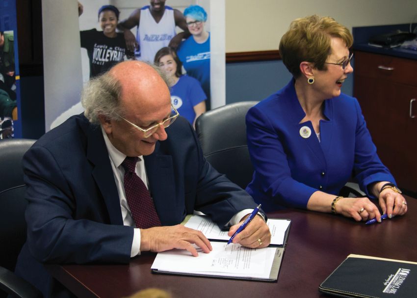 Photo by Julia Johnson Webster University President Elizabeth Stroble signs new nursing agreement with L&C President Dale Chapman.