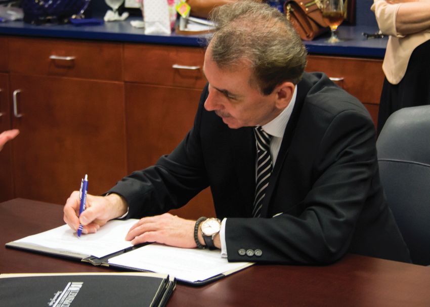 Photo by Julia Johnson Webster University President Elizabeth Stroble signs new nursing agreement with L&C President Dale Chapman.