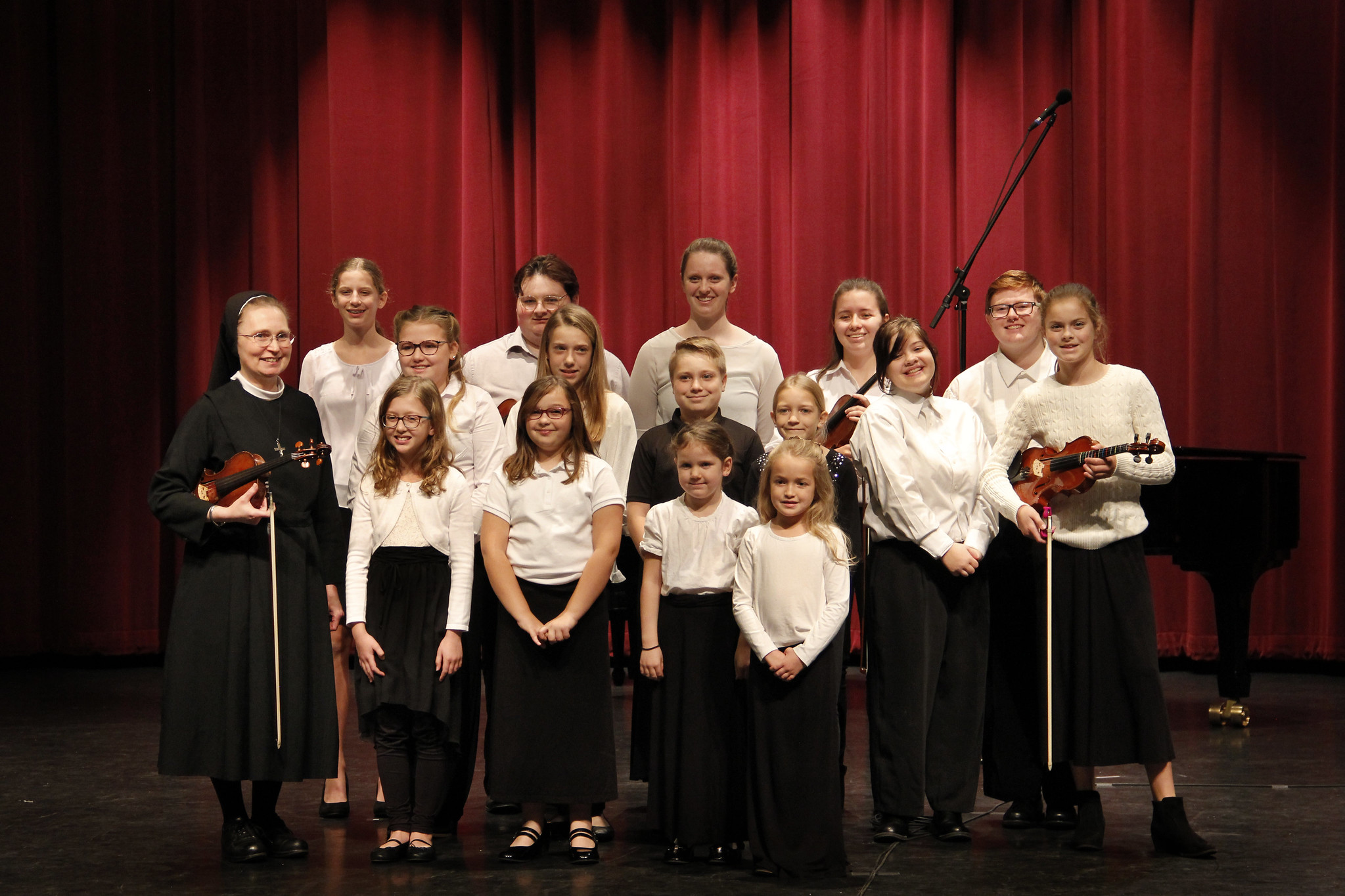 The Violin class of Sister Marie-Therese Swiezynski pose for a group picture after the recital