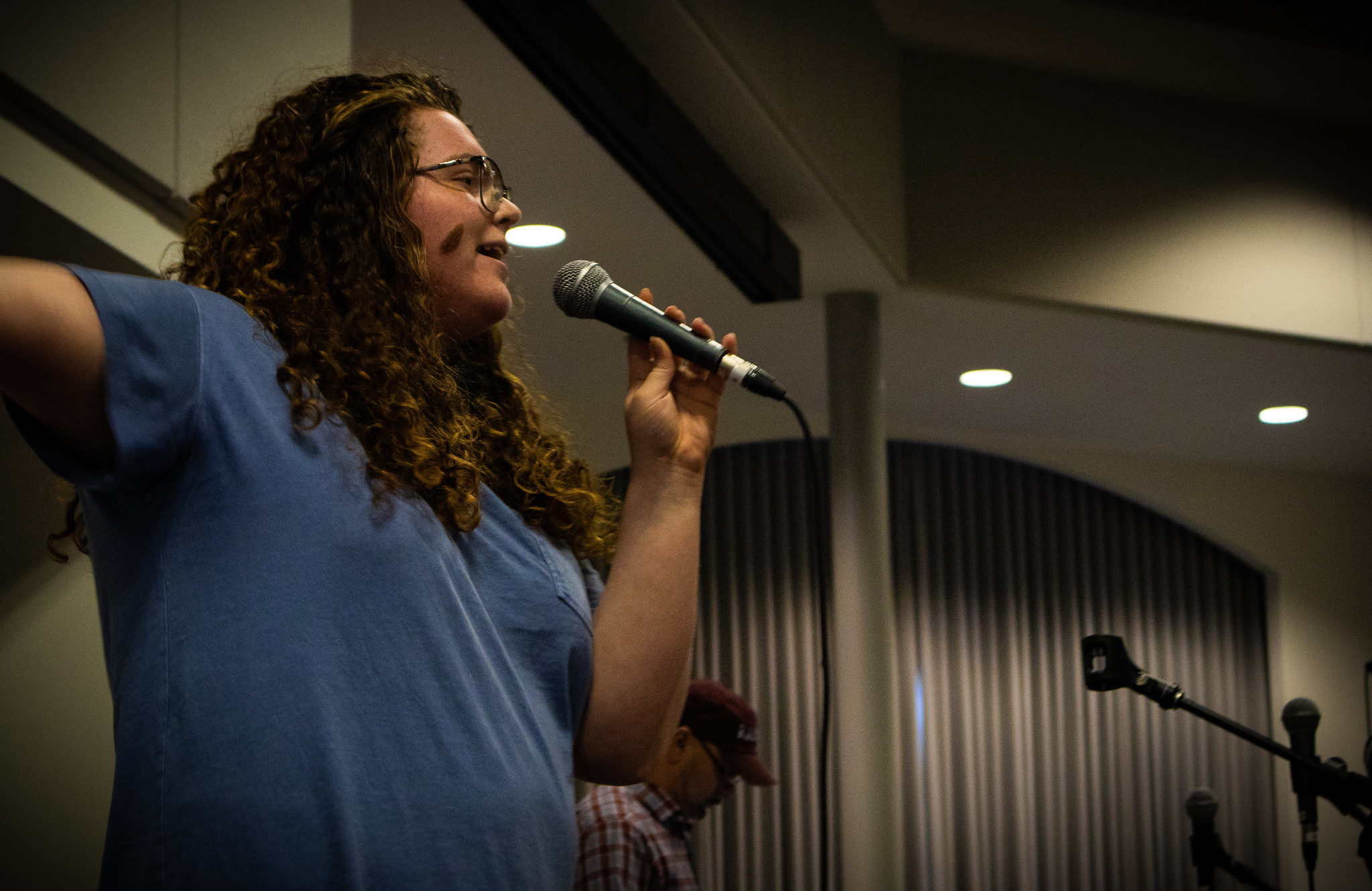 Image of student rocking out while singing karaoke during karaoke contest.