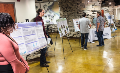 Interns lined up to talk about their projects before presentations start.