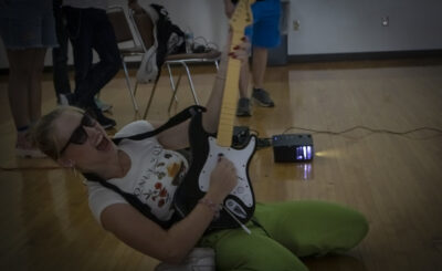 Student rocking out with game guitar