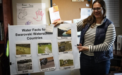 Jennifer Mandeville shows off poster about the Swarovski Water School.