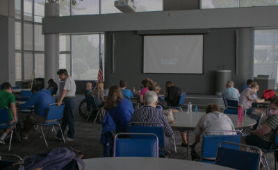 Students and faculty watch a movie together happily