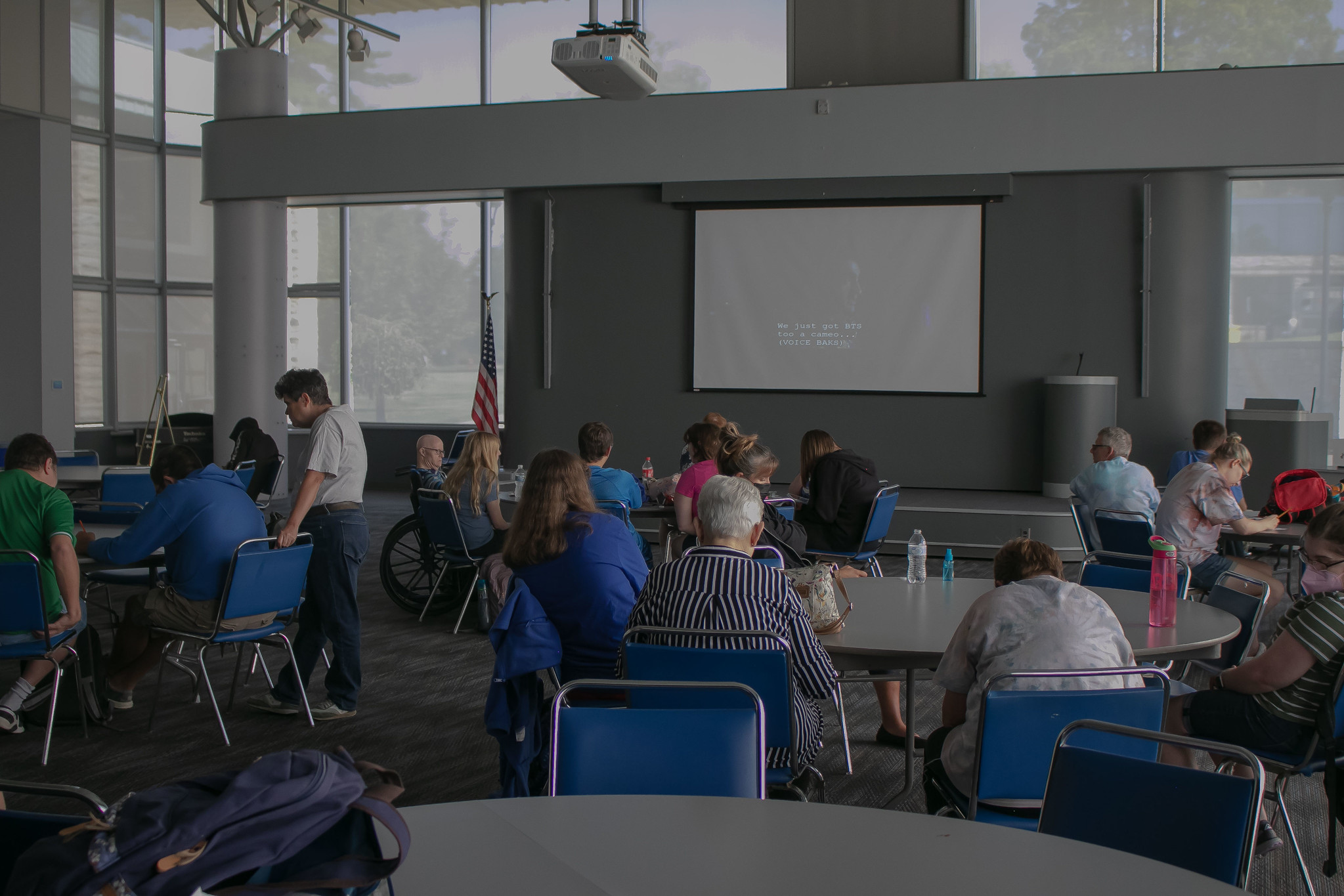 Students and faculty watch a movie together happily
