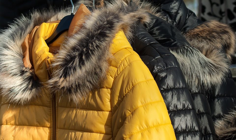 Photo of winter coats hanging on a rack