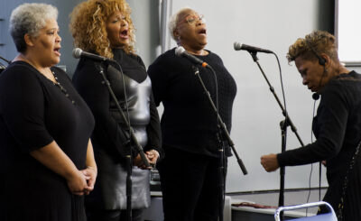 Blancas, led by Brenda Lancaster perform 'My Country Tis Thee'.