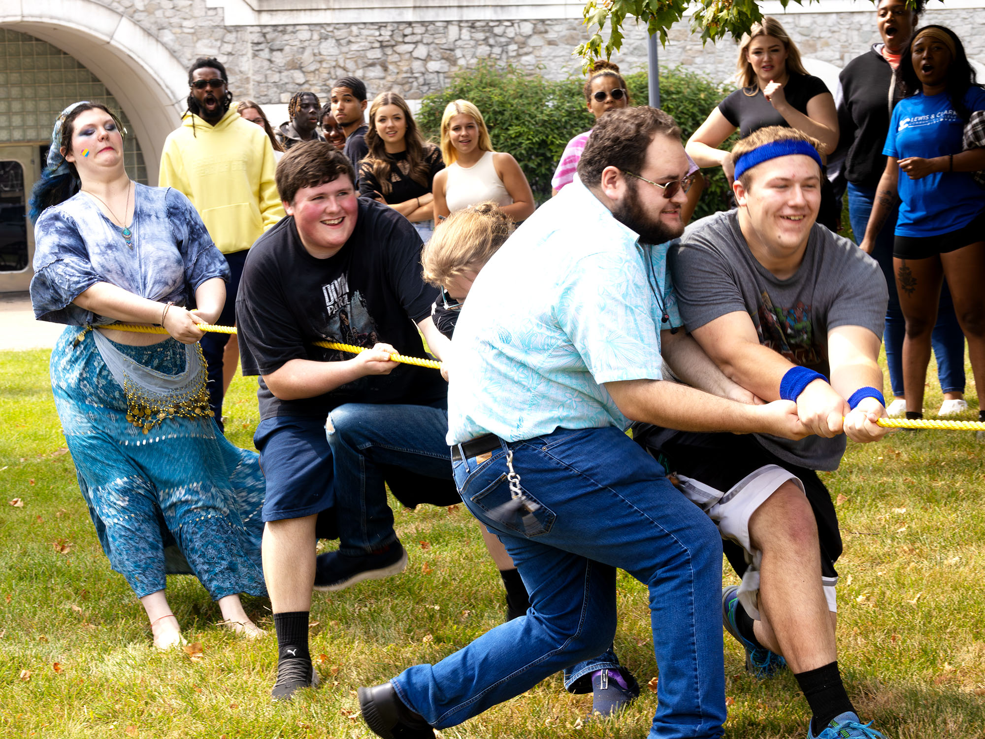 men and women enjoying a game of tug of war