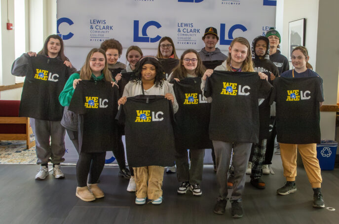 New L&C students holding school shirts
